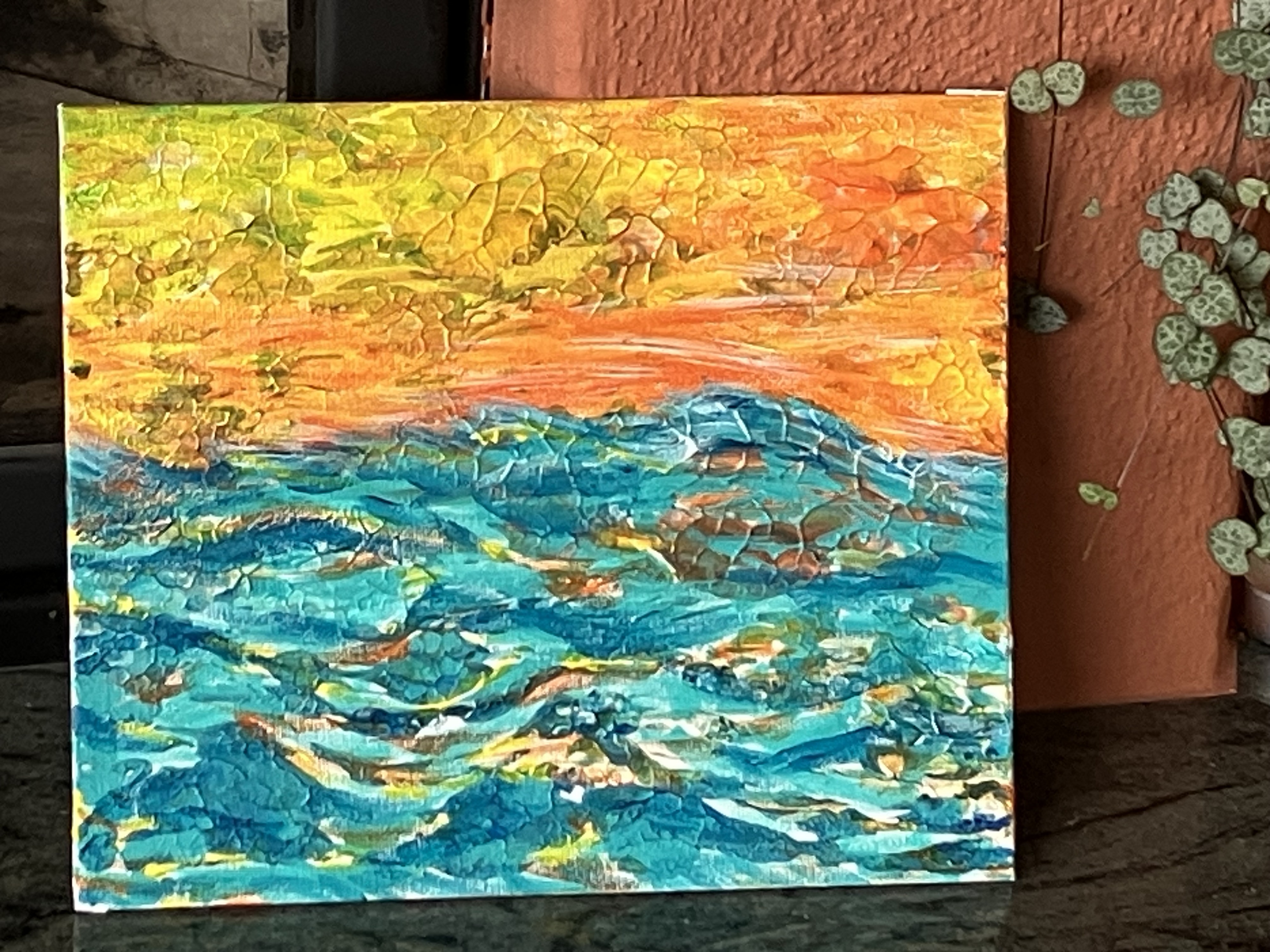Acrylgemälde mit orange-gelbem Himmel über türkisfarbenem, bewegtem Meer